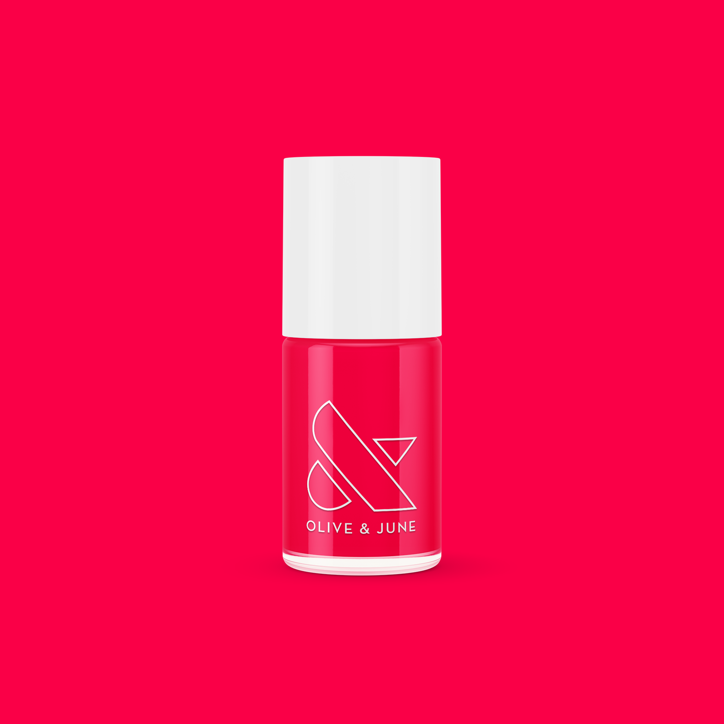 Bottle of Olive and June Hibiscus polish in bright tropical pink on vibrant pink background for mani or manicure.