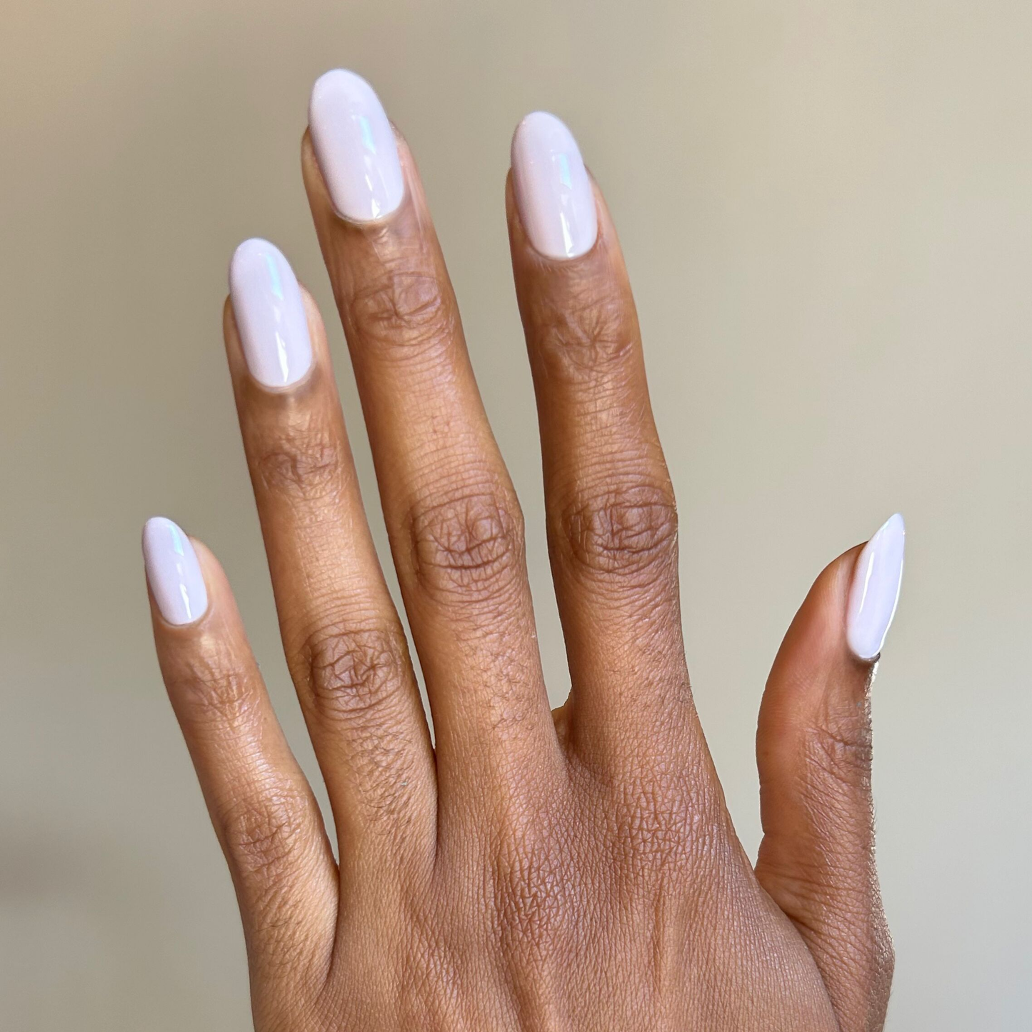 Hand with oval nails painted in Sculpture Wing - Gel cool lavender grey gel polish for a smooth manicure look