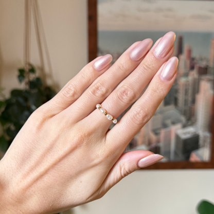Hand with nails painted in shimmering sheer pink using Supernova quick dry gel polish manicure